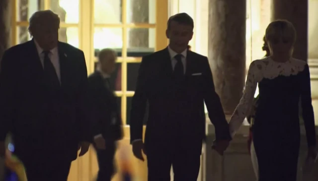 Donald Trump leaves the palace in the darkness, alongside Macron and his wife