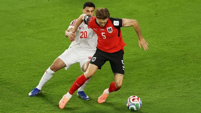 Austria and Jordan players compete for the ball