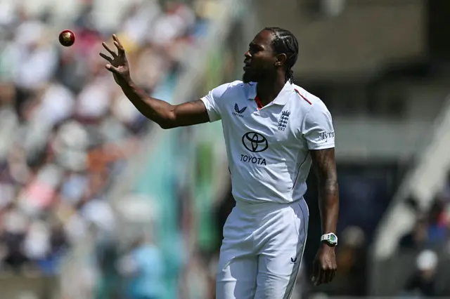 Jofra Archer catching a ball being thrown to his right hand