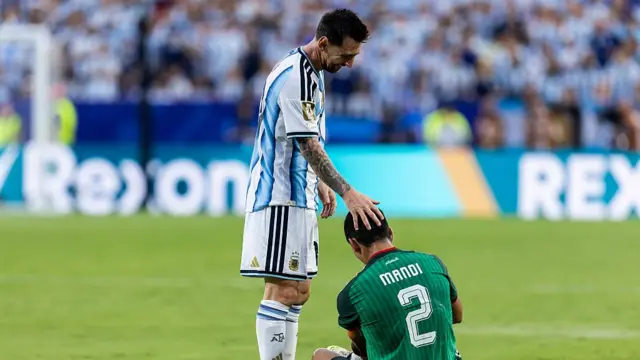 Lionel Messi #10 of Argentina attends to Aïssa Mandi #2 of Algeria after a foul during the FIFA World Cup 2026 Group J match between Argentina and Algeria on June 16, 2026 at the Kansas City Stadium in Kansas City, MO
