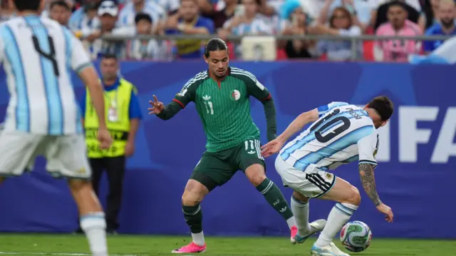 Lionel Messi of Argentina in action against Anis Hadj Moussa of Algeria