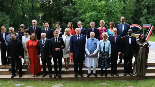 Brazil's First Lady Janja Lula da Silva, Brazil's President Luiz Inacio Lula da Silva, France's President Emmanuel Macron, French President's wife Brigitte Macron, US President Donald Trump, India's Prime Minister Narendra Modi, European Commission President Ursula von der Leyen, European Commission President's husband Heiko von der Leyen, (2nd row From L) European Council President Antonio Costa, Japan's Prime Minister Sanae Takaichi, wife of Switzerland's President Caroline Merotto, Switzerland's President Guy Parmelin, South Korea's President Lee Jae-myung, British Prime Minister's wife Victoria Starmer, Britain's Prime Minister Keir Starmer Canada's Prime Minister Mark Carney, British economist and Canadian Prime Minister's wife Diana Carney pose for a family photograph during a gala dinner as part of the G7 summit, in Evian, eastern France.
