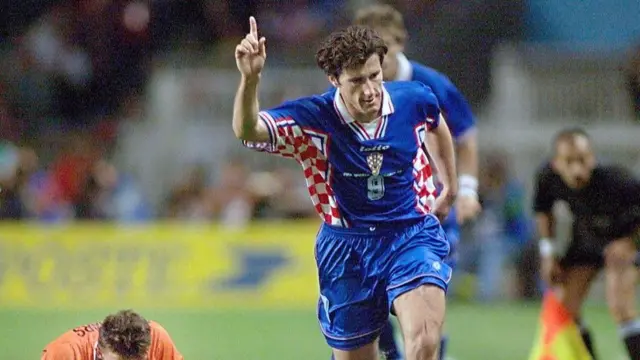 Croatian forward Davor Suker (C) dribbles past Dutch forward Marc Overmars (L) during the 1998 Soccer World Cup third place play-off between the Netherlands and Croatia 11 July at the Parc des Princes stadium in Paris. Suker secured third place at the World Cup for debutants Croatia and set himself up for the golden boot, scoring his sixth goal of the event to complete a 2-1 win over the Netherlands.