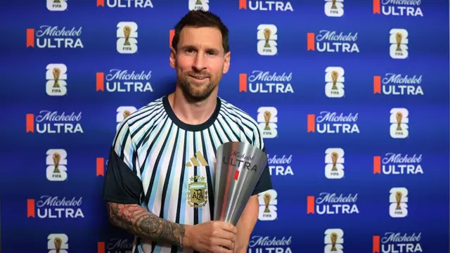 Lionel Messi holds the player of the match award