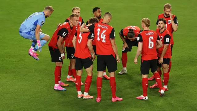 Austria players in a huddle
