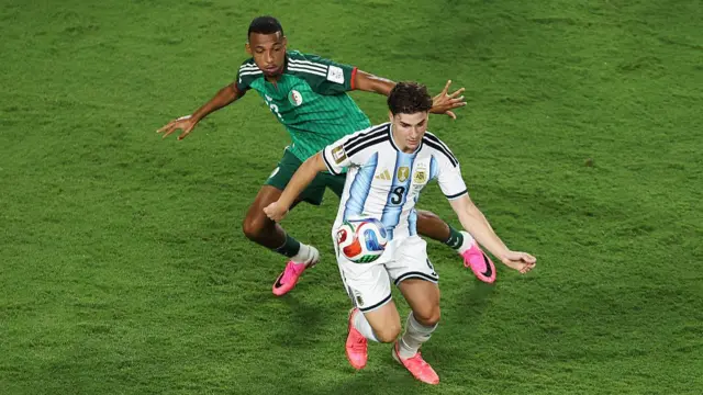 Julian Alvarez controls the ball against Rafik Belghali