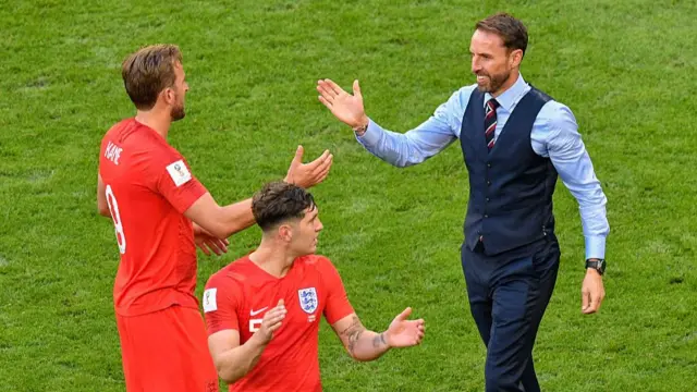 ngland's coach Gareth Southgate (R), England's defender John Stones (C) and England's forward Harry Kane (L) celebrate after winning the Russia 2018 World Cup quarter-final football match between Sweden and England at the Samara Arena in Samara on July 7, 2018. (