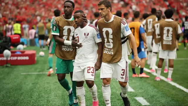 Assim Madibo #23 of Qatar walks off with his teammates as he receives a red card during the FIFA World Cup 2026 Group B match between Canada and Qata