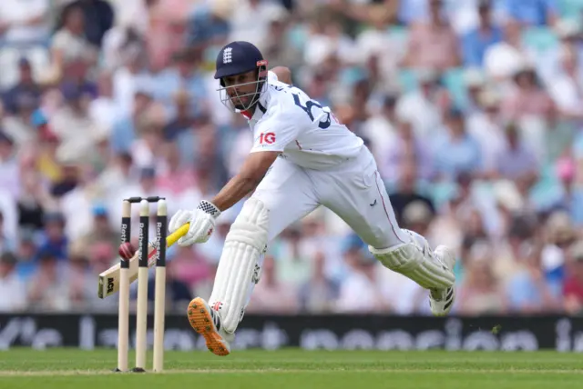 Emilio Gay runs towards the stumps with ball approaching