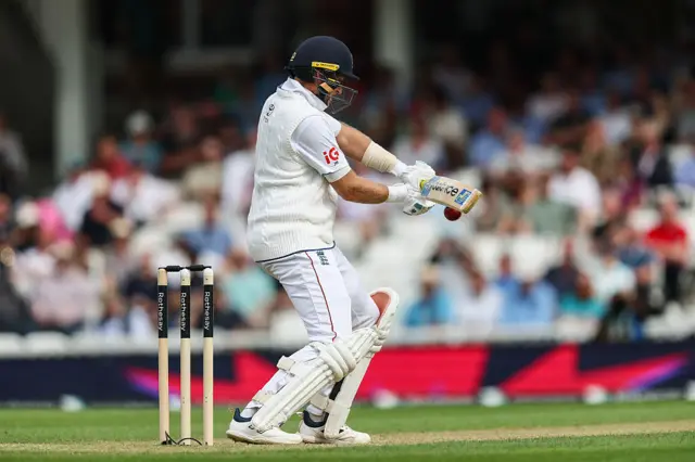 Joe Root in action batting the ball to his left-making a good connection