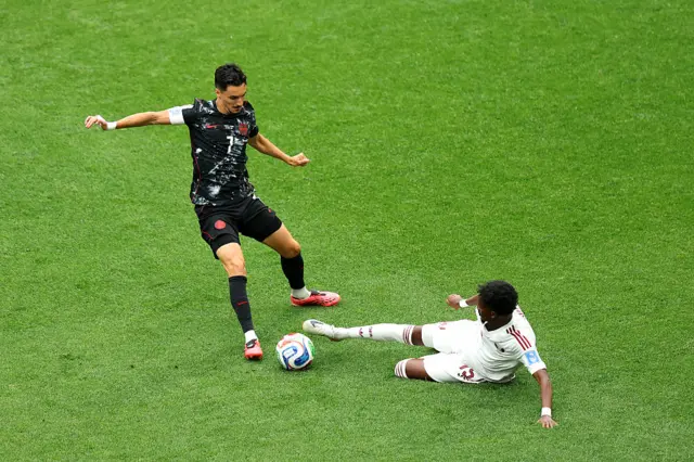 Stephen Eustaquio #7 of Canada and Yusuf Abdurisag #15 of Qatar compete for the ball before the FIFA World Cup 2026 Group B match between Canada and Qatar