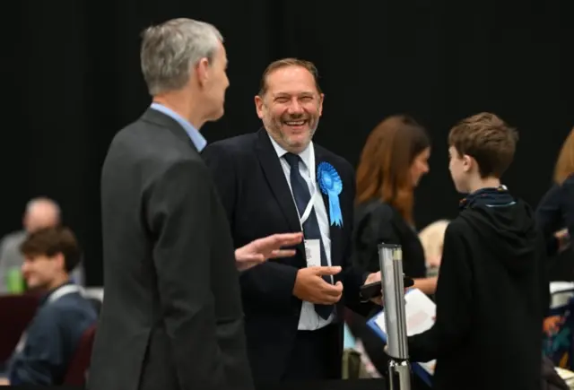 Scottish Conservative Party candidate Douglas Lumsden (centre) in good spirits as votes are counted for the Aberdeen South by-election at P&J Live in Aberdeen