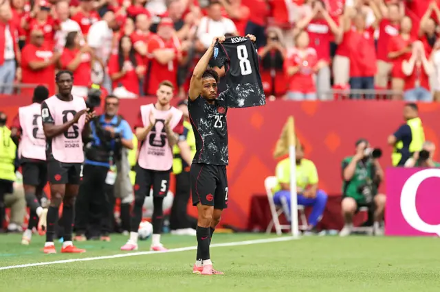 Nathan Saliba #25 of Canada shows the shirt of Ismael Kone #8 as the celebration after scoring the team's fourth goal during the FIFA World Cup 2026 Group B match between Canada and Qatar