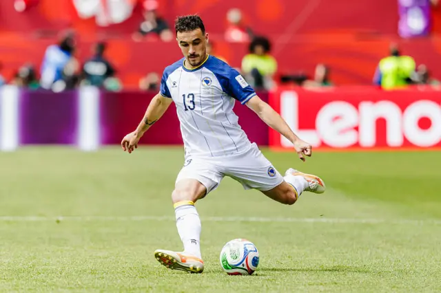 Bosnia midfielder Ivan Basic crosses the ball