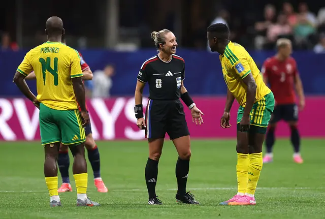Referee Tori Penso speaks with Teboho Mokoena