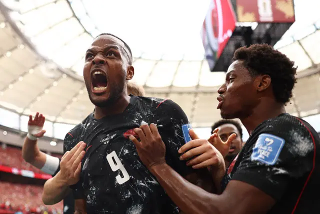 Cyle Larin #9 of Canada celebrates with teammates after scoring his team's first goal during the FIFA World Cup 2026 Group B match between Canada and Qatar