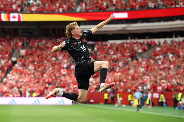 Jacob Shaffelburg #14 of Canada celebrates the team's fifth goal scored own goal by Mohamed Manai #26 of Qatar during the FIFA World Cup 2026 Group B match between Canada and Qatar