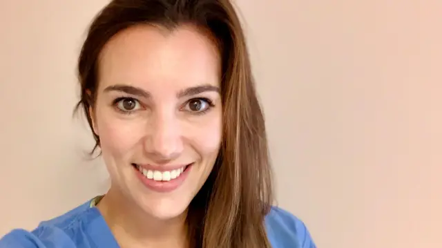 Dr Brooke Vandermolen smiling in scrubs and taking a selfie