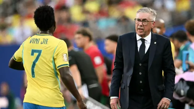 Brazil's Italian head coach Carlo Ancelotti speaks to forward #07 Vinicius Junior