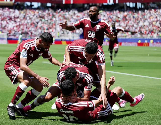 Qatar celebrate their late equaliser against Switzerland