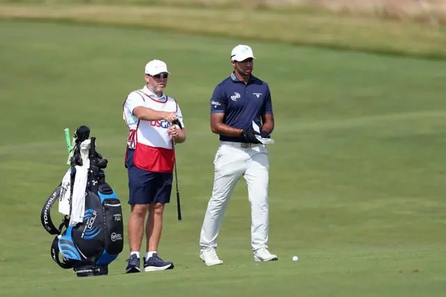 Aaron Rai with his caddie