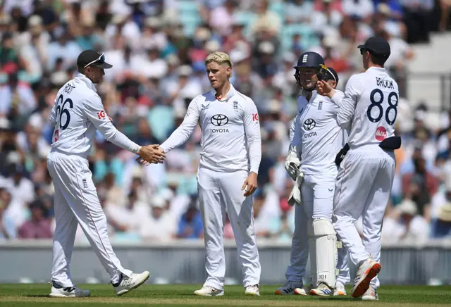 Joe Root and Jacob Bethall celebrate after wicket.