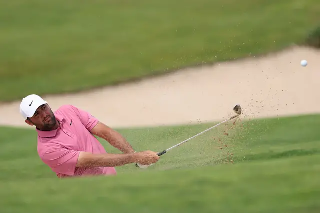 Scottie Scheffler chips out of a bunker