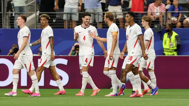Harry Kane of England celebrates with teammates after scoring a penalty
