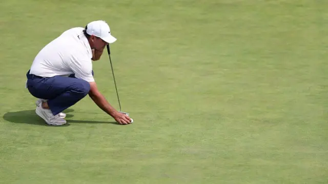 Brooks Koepka lines up a putt