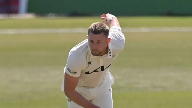Gus Atkinson bowling for Surrey in the County Championship