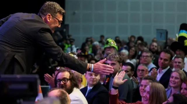 Newly elected Makerfield MP Andy Burnham of Britain's Labour Party greets a supporter