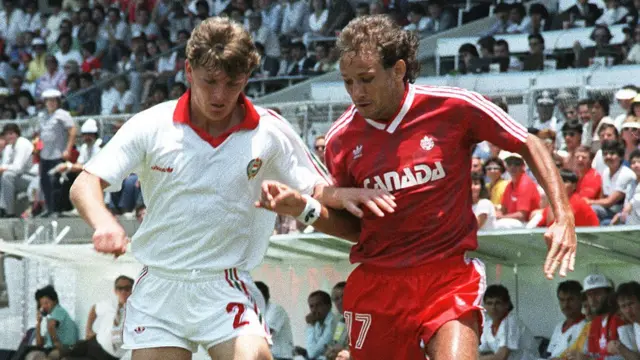Hungarian defender Sandor Sallai (L) fights for the ball with Canadian David Norman