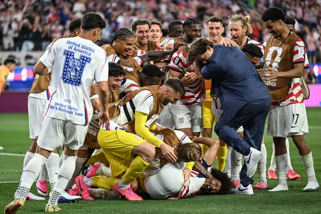 The USA celebrate scoring against Paraguay