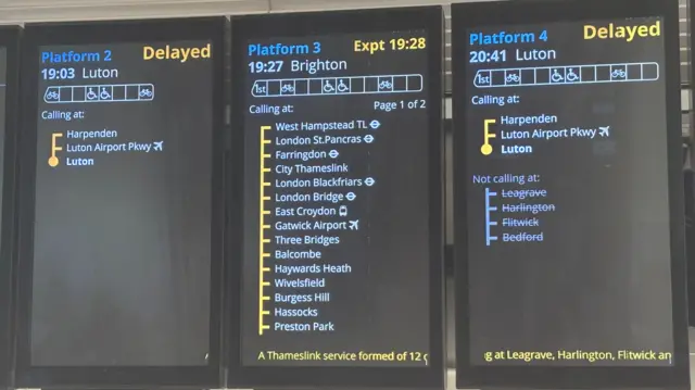 Three train information screens. One for the 19:03 for Luton, one for 19:27 for Brighton, another for the 20:41 for Luton
