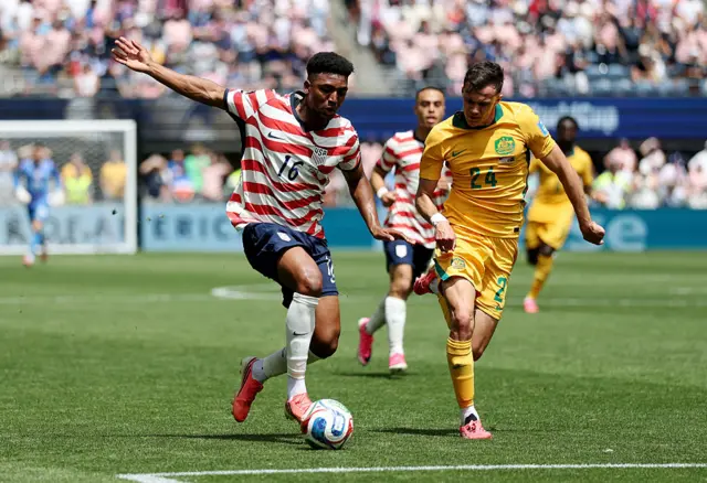 Alex Freeman controls the ball against Paul Okon-Engstler
