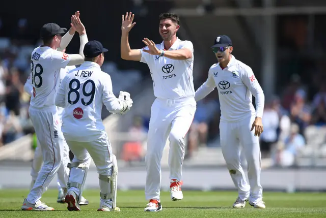 Josh Tongue celebrates with the rest of the England team after dismissing Devon Conway