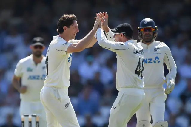 New Zealand's Matt Henry and Tom Latham celebrate wicket.