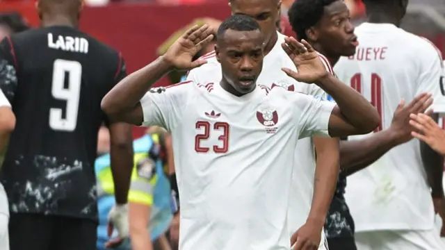 Assim Madibo of Qatar shocked after the injury to Ismael Kone of Canada