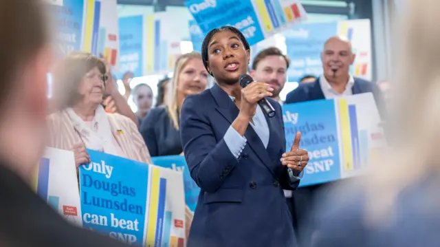 Kemi speaks into a microphone at a Tory rally in Aberdeen South