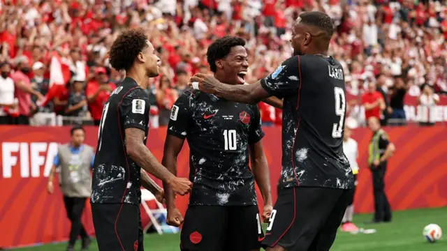 Jonathan David #10 of Canada celebrates with teammates after Tajon Buchanan #17 and Cyle Larin