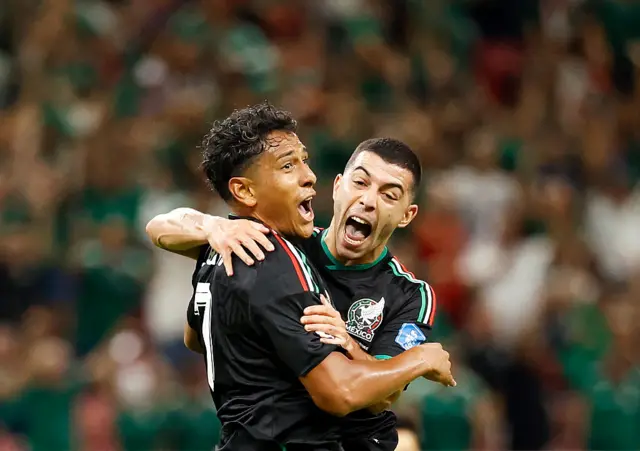 Luis Romo celebrates with teammate midfielder #06 Erik Lira scoring his team's first goal during the 2026 World Cup Group A football match between Mexico and South Korea