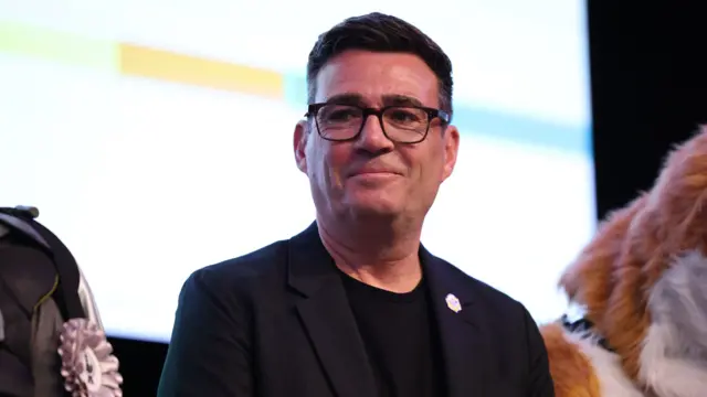 Labour Party candidate Andy Burnham on stage before being confirmed as the winner of the Makerfield by-election in Wigan