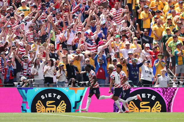 Players of the United States celebrate the team's first goal