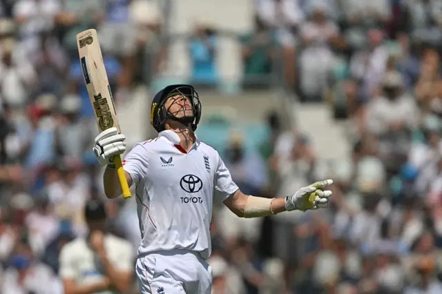 England's Matt Fisher looks to the sky in celebration of reaching half-century.