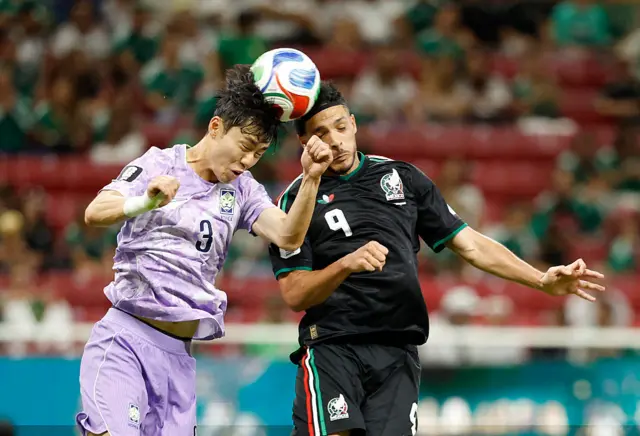 Lee Gi-hyuk and Mexico's forward #09 Raul Jimenez fight for the ball during the 2026 World Cup Group A football match between Mexico and South Korea