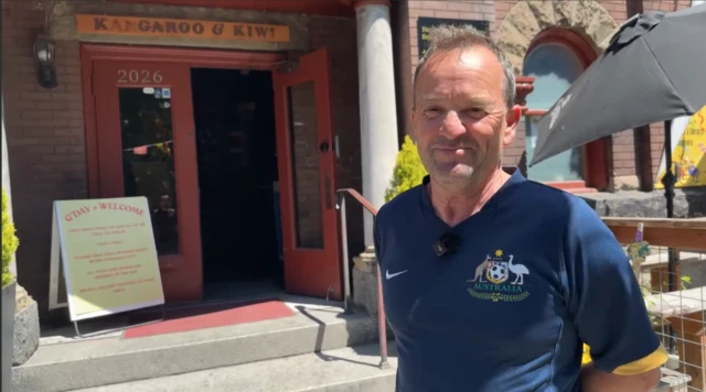 The owner of Kangaroo & Kiwi stands outside the pub