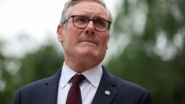 British Prime Minister Keir Starmer looks on as he awaits Switzerland's Federal President Guy Parmelin on the sidelines of the G7 summit on June 16, 2026