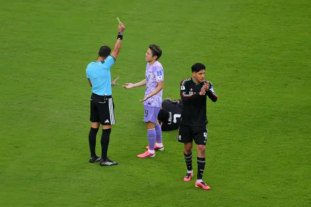 Kang-In Lee #19 of Korea Republic receives a yellow card by Referee Gustavo Tejera during the FIFA World Cup 2026 Group A match between Mexico and Korea Republic