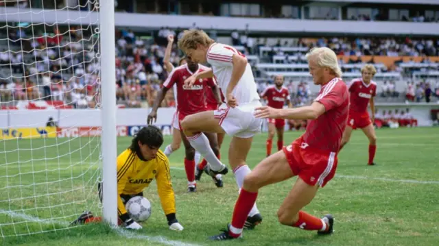 Sergei Rodinov of the USSR is foiled by goalkeeper Tino Lettieri and Ian Bridge of Canada