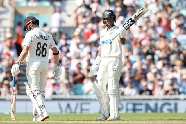 Rachin Ravindra celebrates hitting 50 runs.